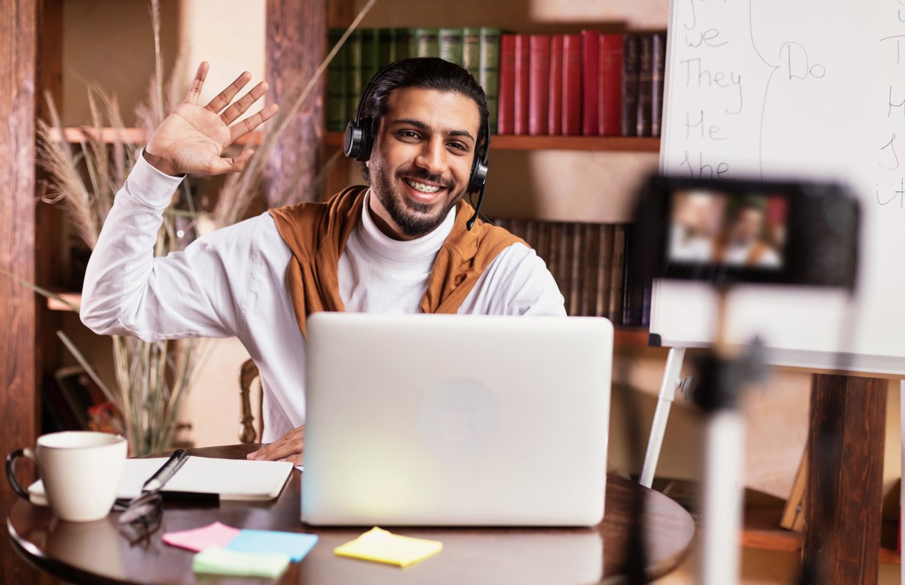Teacher At Laptop Teaching English Online Making Video Lesson Indoors